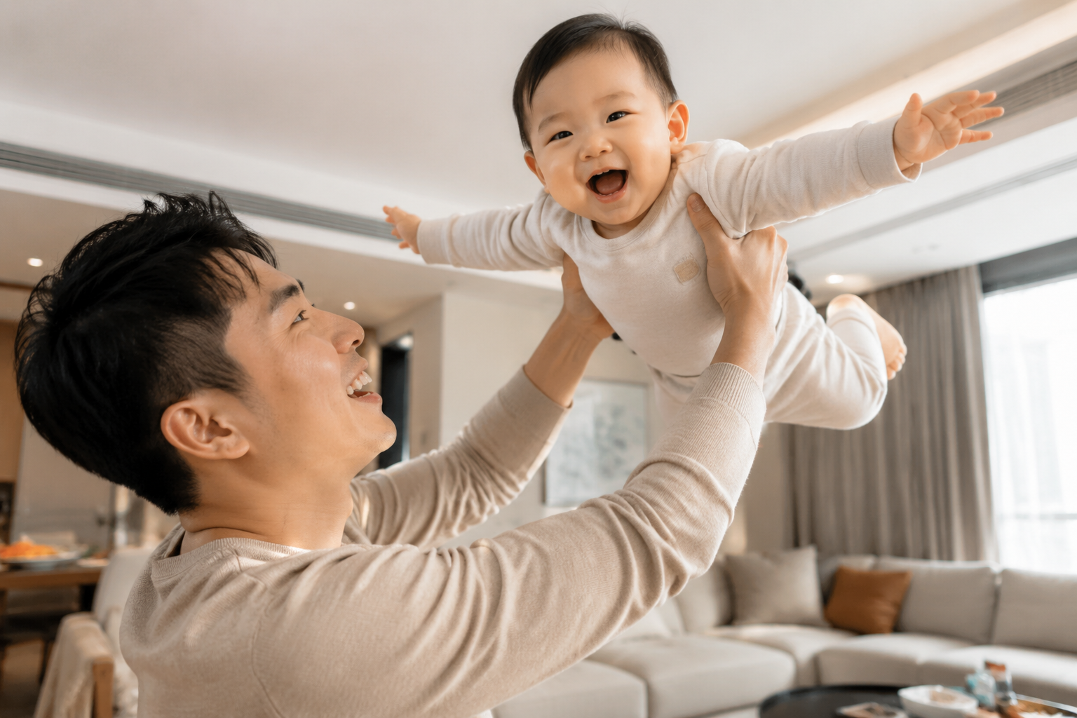 A handsome Chinese young father playing an 