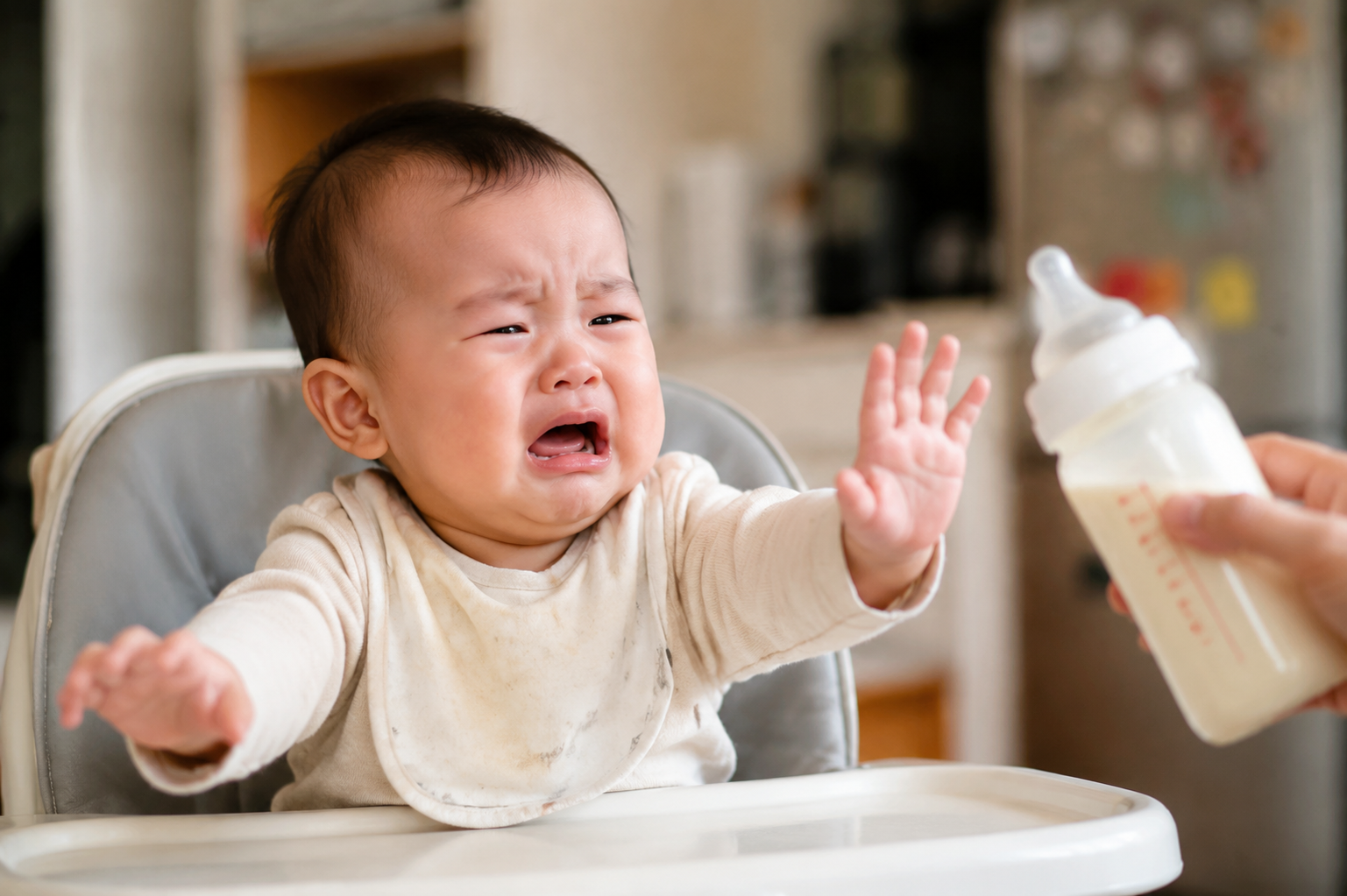 A cute 8-month-old Chinese baby looking fussy and crying gently, pushing away a baby milk bottle. Bright indoor home environment, warm soft lighting, photorealistic, cinematic lighting, 8k resolution, highly detailed --ar 3:4