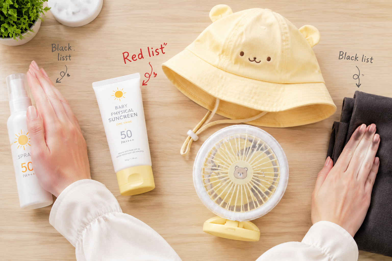Close up flatlay on a neat light wooden desk. A pair of young Asian female hands are organizing baby sun protection items. The hands are confidently pushing away a spray sunscreen bottle and a thick dark cloth (representing the black list) to the edge of the frame, while keeping a baby physical sunscreen tube (zinc oxide), a cute light-yellow baby bucket hat, and a mini stroller fan with a safety net (representing the red list) in the center. High-quality product photography style, bright studio lighting, soft pastel colors, highly detailed, 8k resolution.
