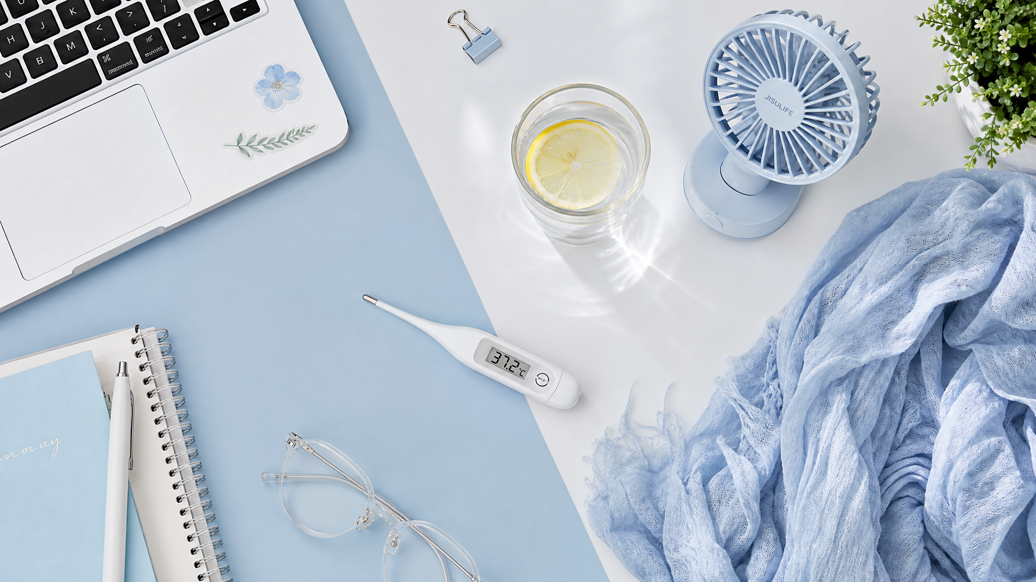 A beautiful flatlay of a modern office desk with a light blue and white color palette, featuring a cute mini desk fan, a glass of water with lemon, a soft thin shawl, and a digital thermometer showing 37.2 degrees Celsius, top-down view, bright and airy lighting, realistic photography, highly detailed.
