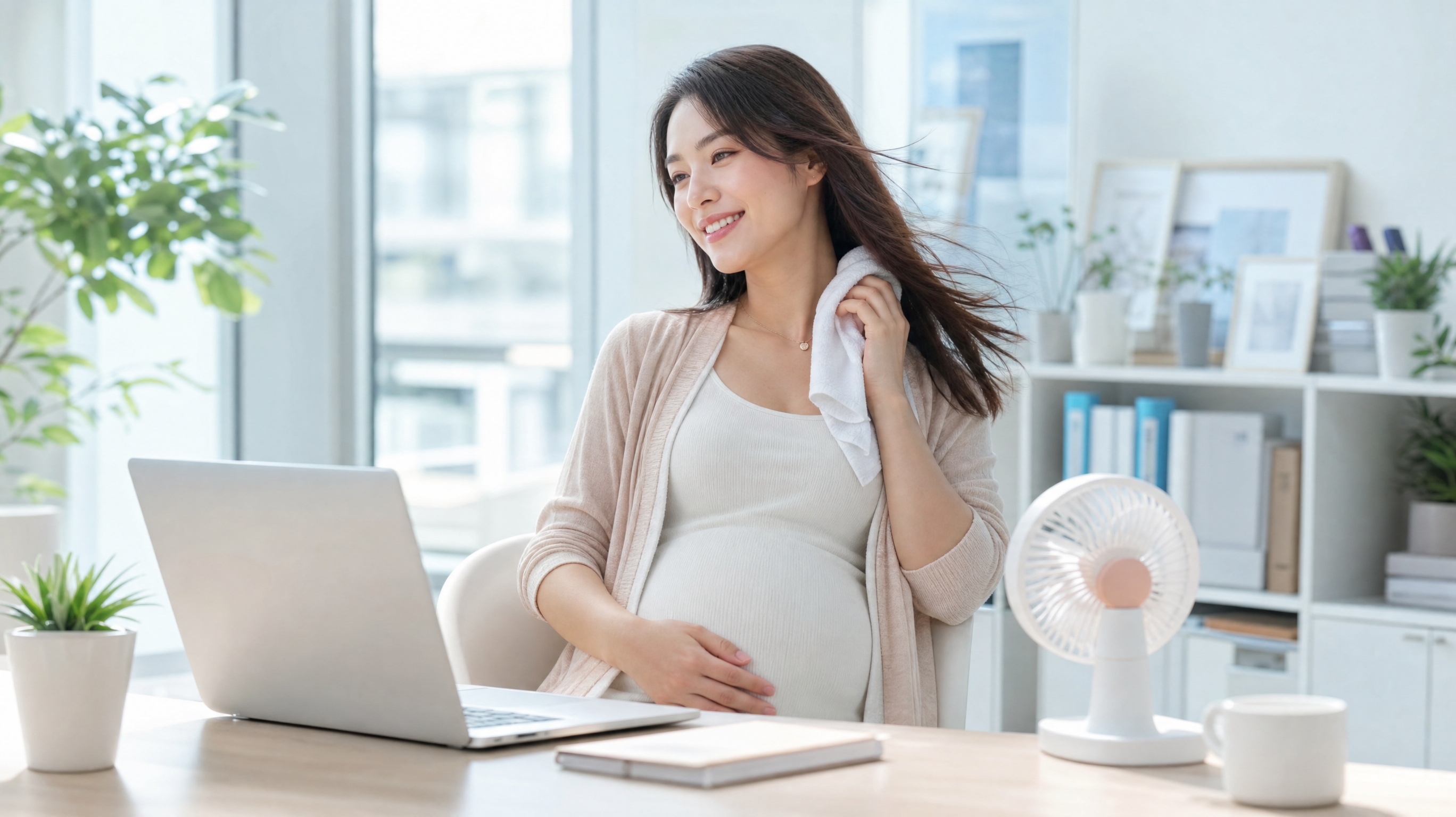 A smiling Chinese pregnant woman in an office setting, gently wiping her neck with a soft damp towel, a small aesthetic desk fan blowing gently, wearing a stylish layered outfit with a light cardigan, bright and fresh atmosphere, soft pastel colors, high-quality commercial photography, 8k.