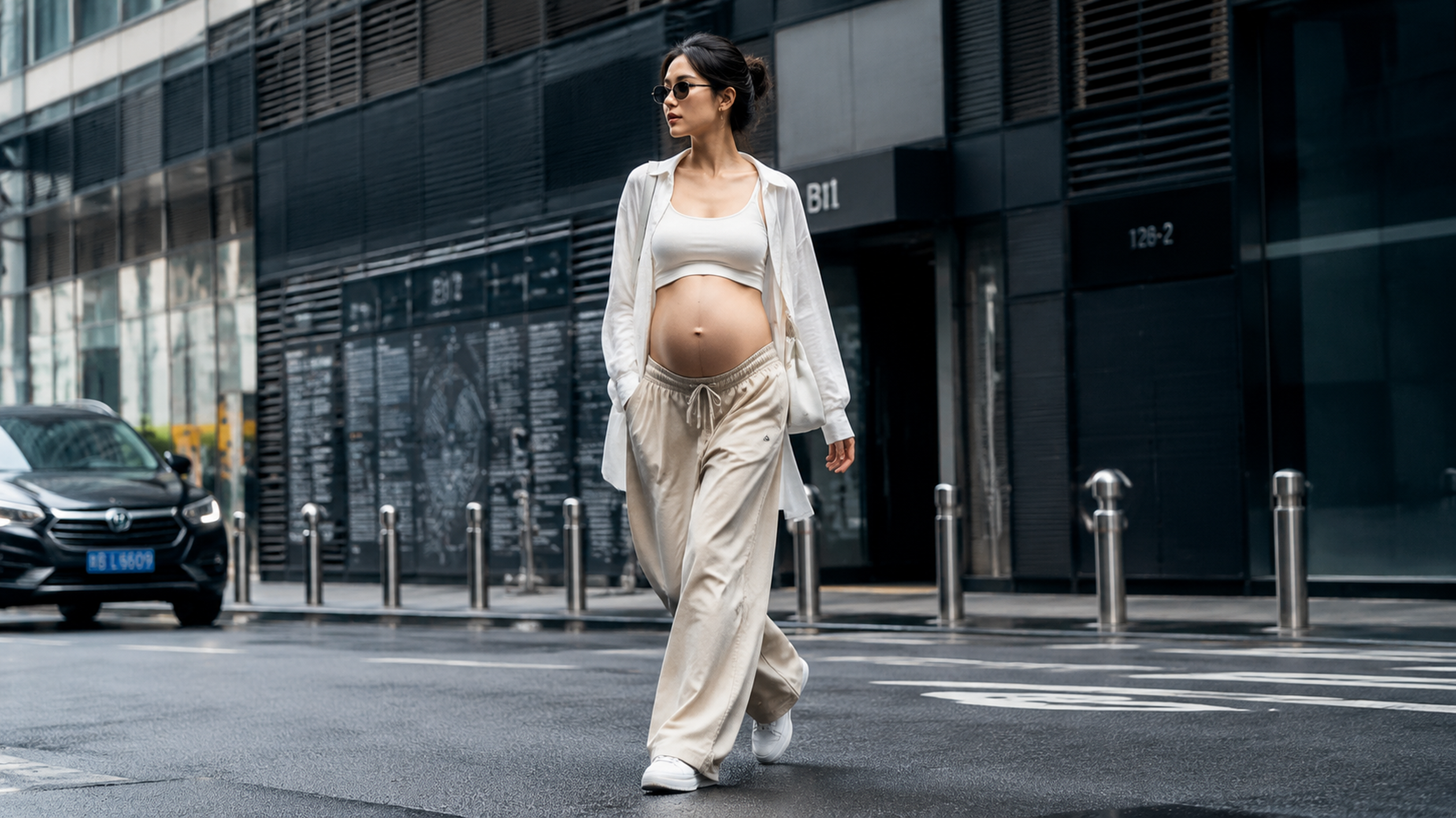 A stylish Chinese pregnant woman walking on a city