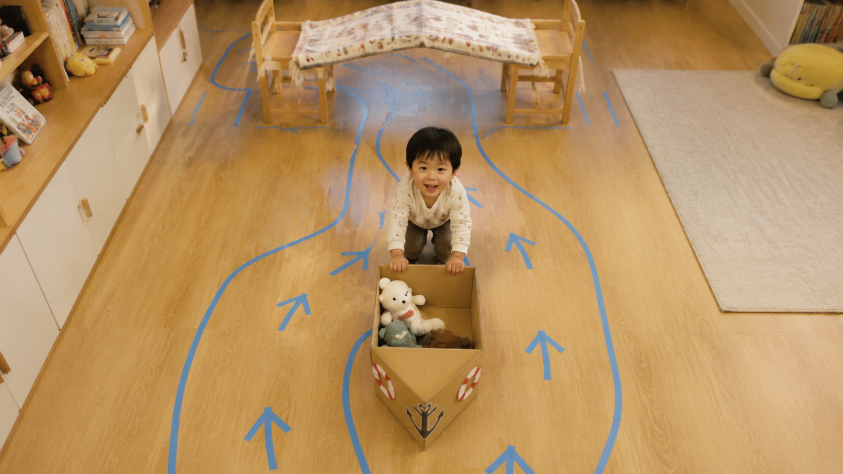 A top-down view of a cute Chinese toddler playing 