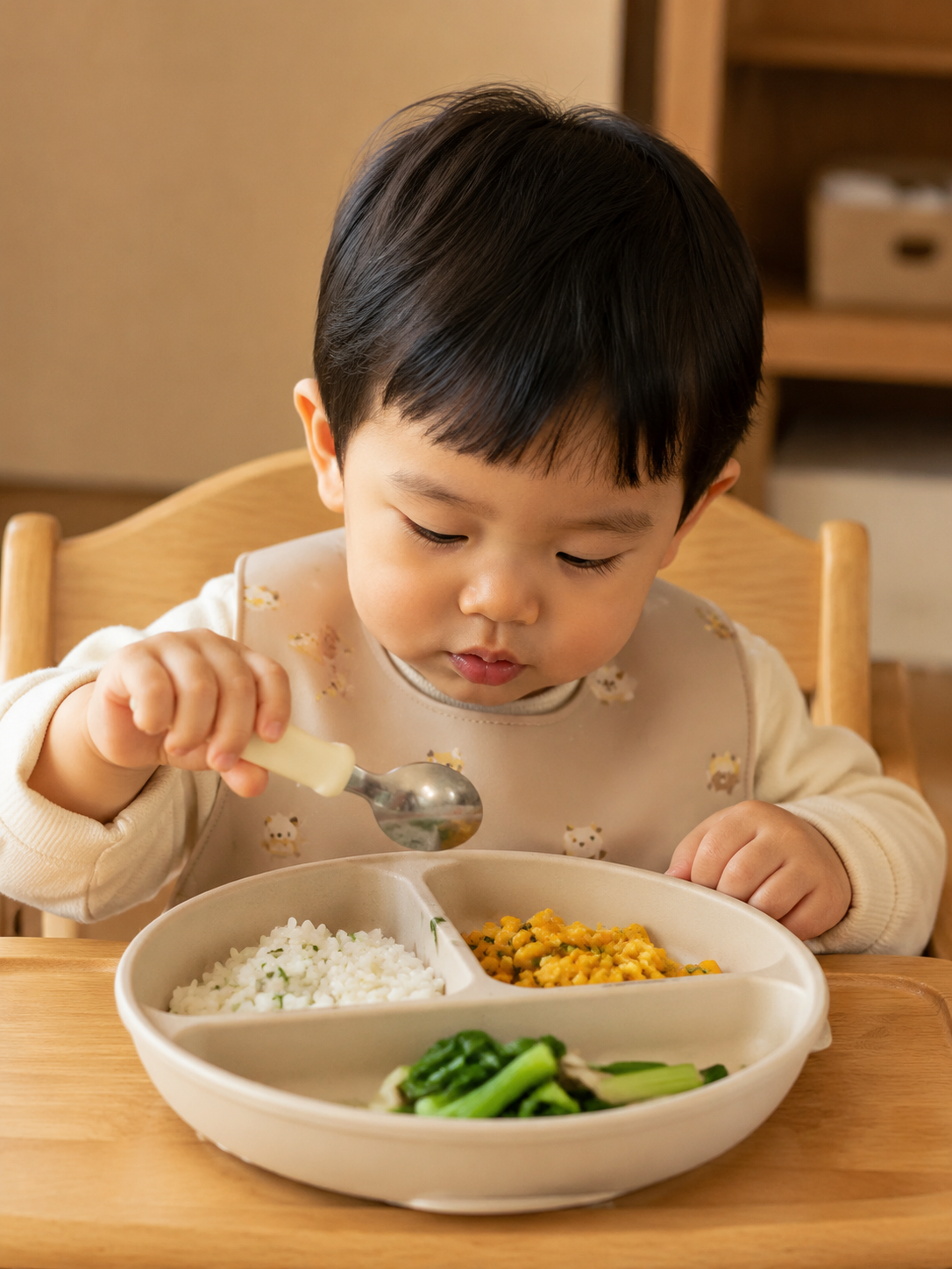 A cute 2-year-old Chinese toddler sitting in a hig