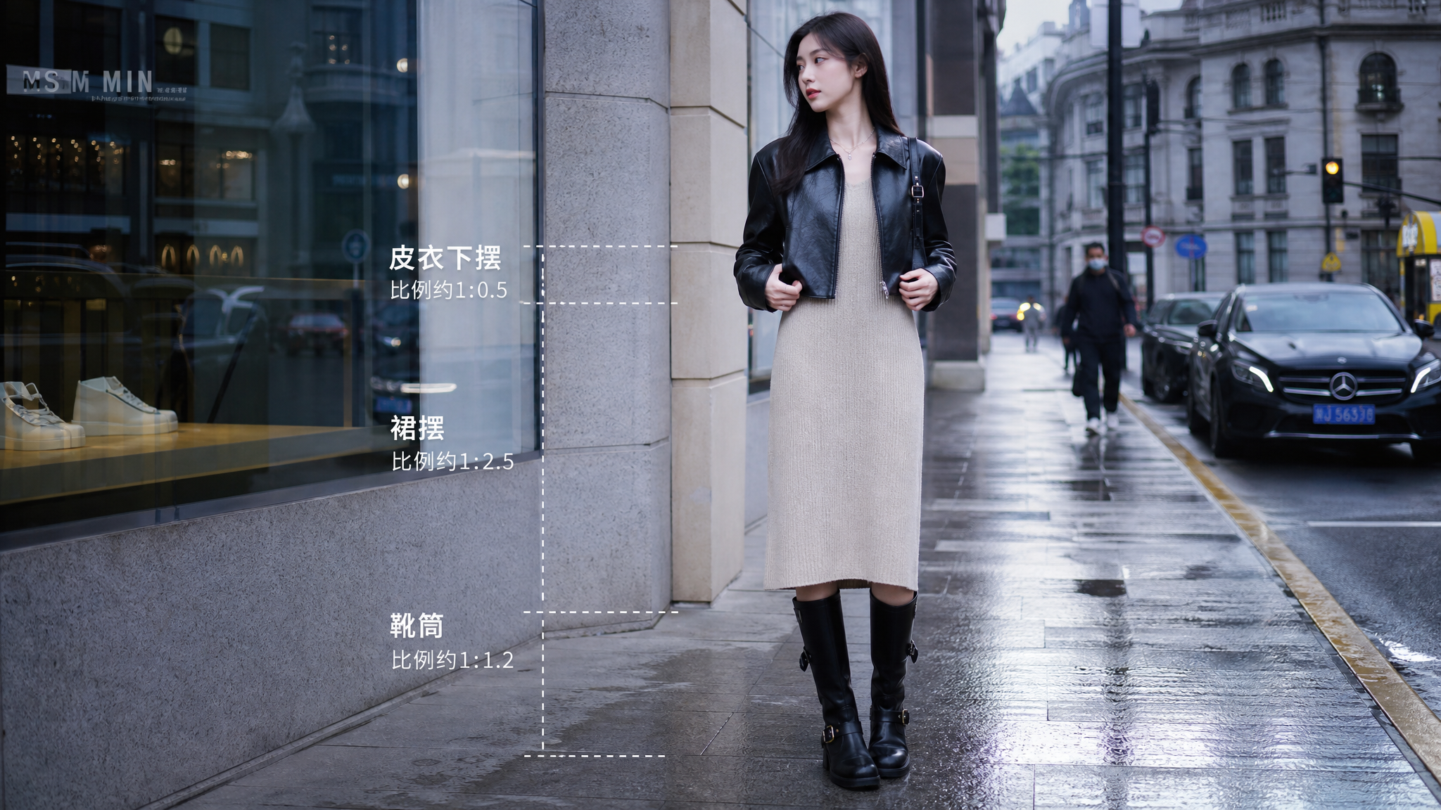中国年轻女性街拍造型,站在上海城市街头人行道上,人物自然站立微侧身,双手轻扶黑色短款皮衣衣摆,穿黑色